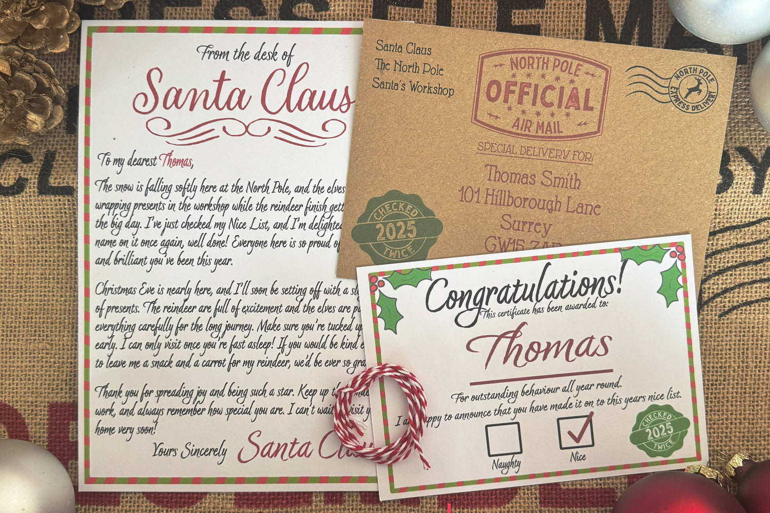 Letter from Santa Claus, certificate, and envelope with red and white twine.