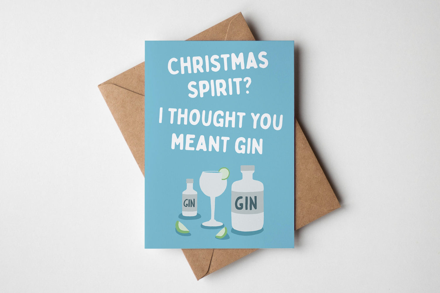 Card with 'Christmas Spirit? I Thought You Meant Gin' text and gin bottle and glass illustrations on a blue background.
