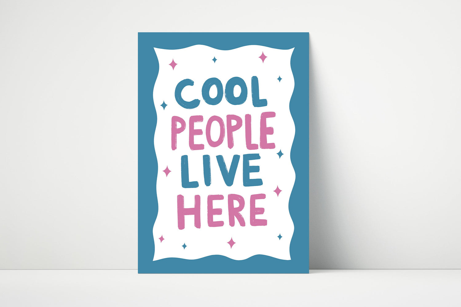 Bold and fun handwritten "Cool People Live Here" print in pink and blue.