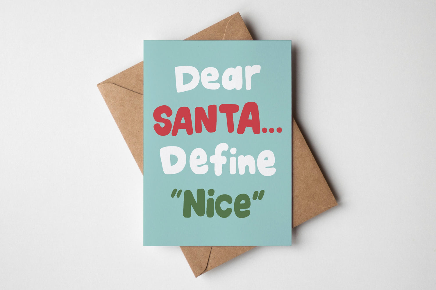 Card with text 'Dear Santa... Define Nice' on a light blue background with a brown envelope.
