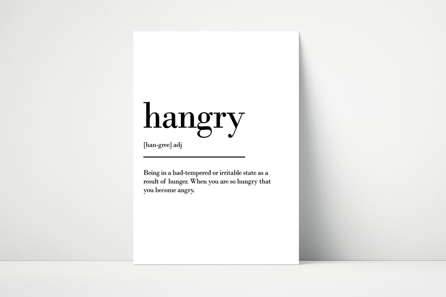 Wall art print featuring the definition of “hangry” in a modern dictionary style, perfect for humorous kitchen or dining room décor.