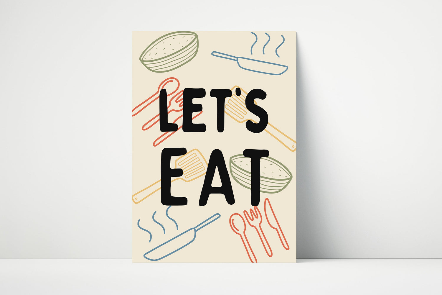 A wall art print with the text 'LET'S EAT' in bold black letters, surrounded by colorful abstract illustrations.