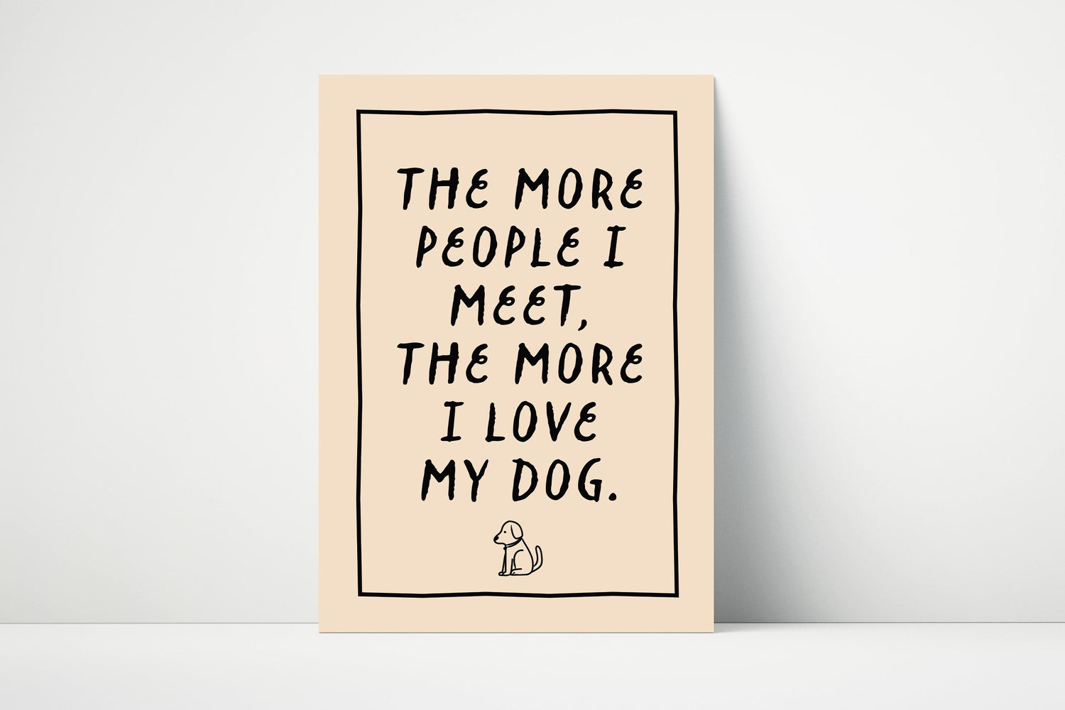 Typography wall art print that says "the more people I meet, the more I love my dog." In bold text printed on matte paper.