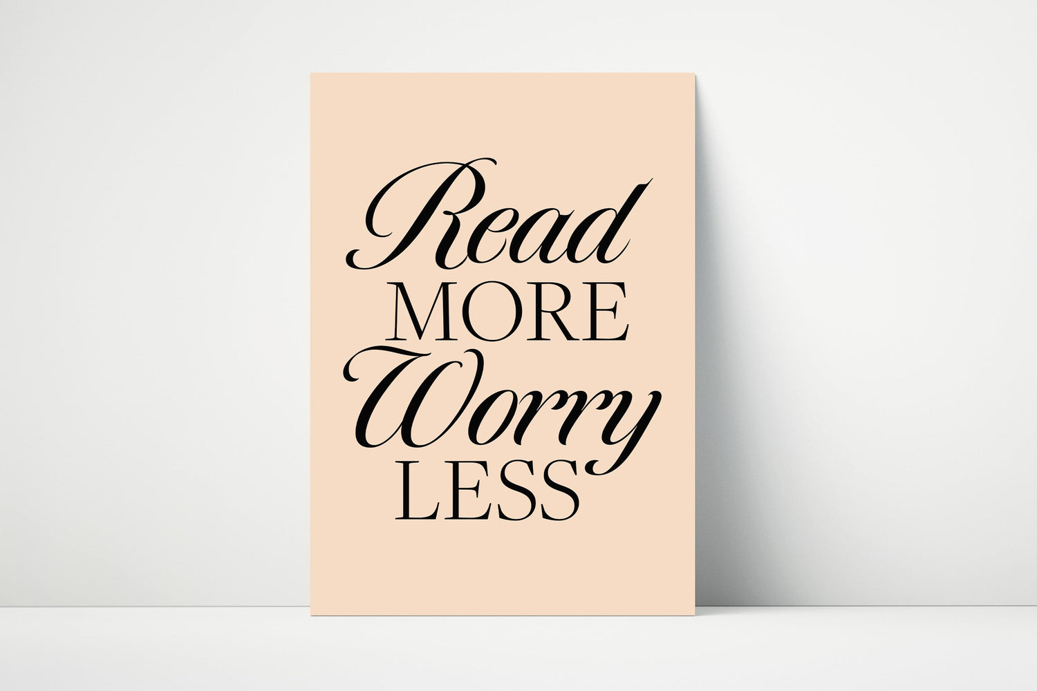 A poster with the text 'Read More Worry Less' printed in black on a beige background.