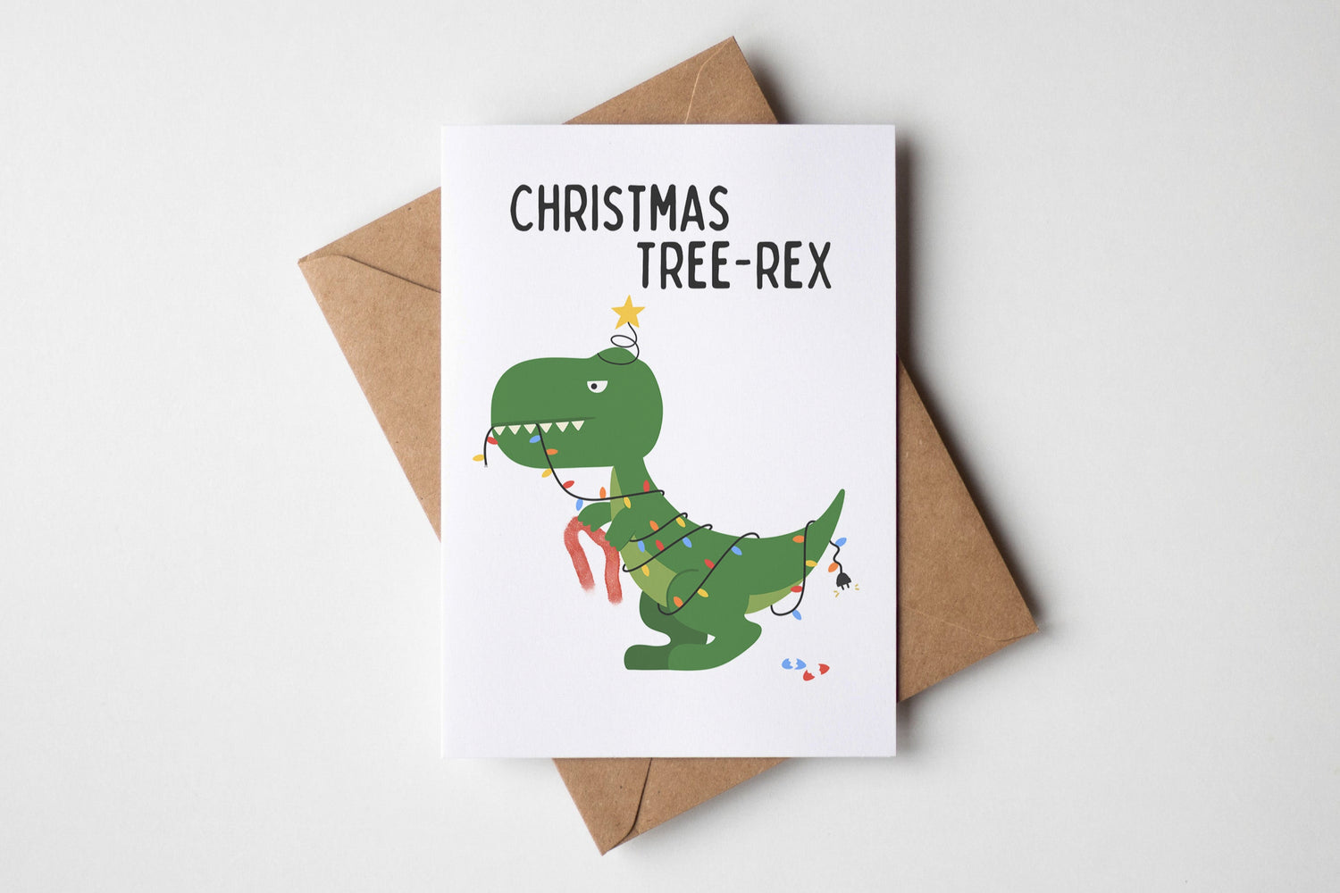 Christmas card with a dinosaur illustration and 'Christmas Tree-Rex' text on a white background.