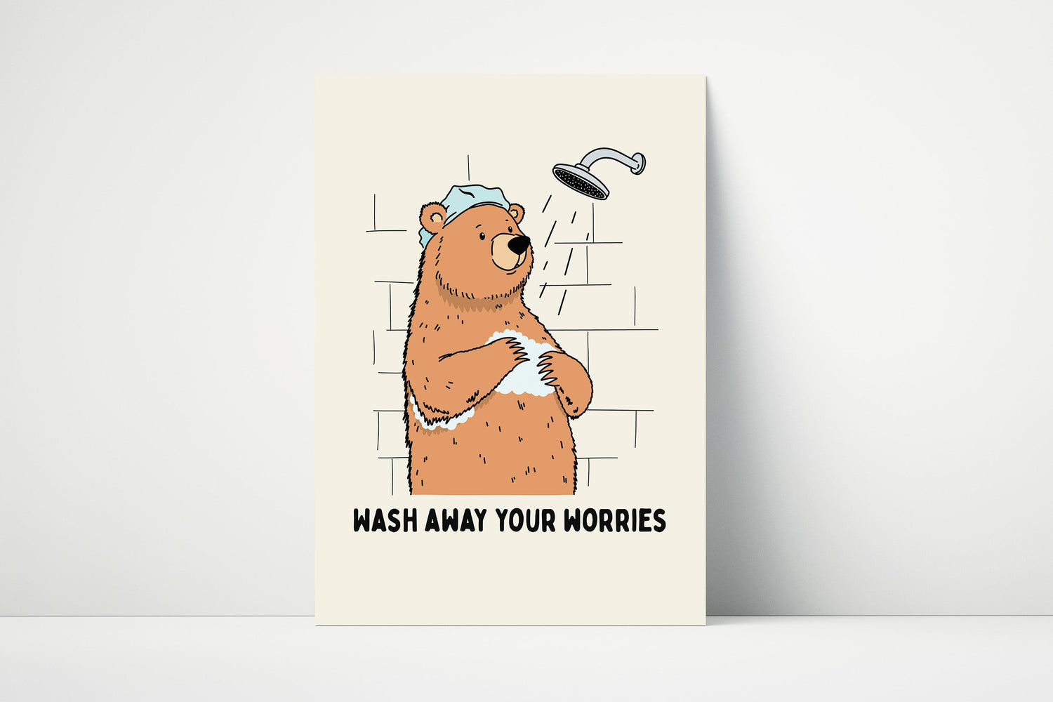 Bathroom wall art print with a bear in the shower and the phrase “Wash Away Your Worries,” perfect for calming, cosy, and whimsical bathroom décor.