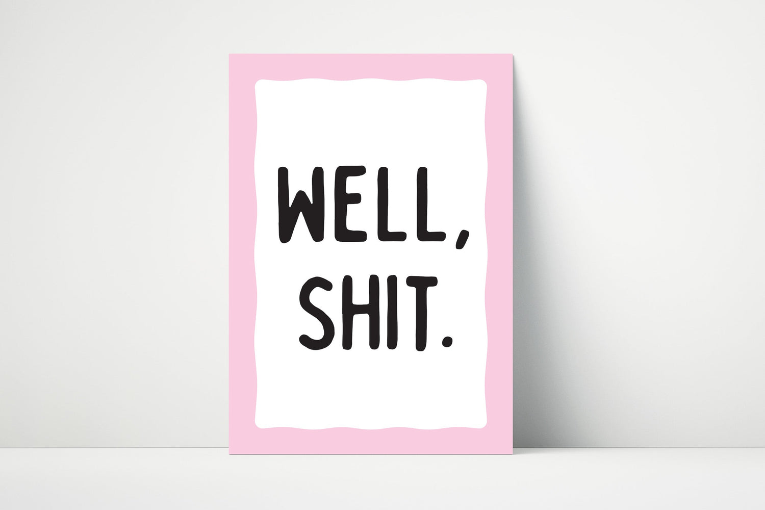 Minimalist wall art print with the phrase “Well Shit” in bold black text on a white background, with a blue or pink border.