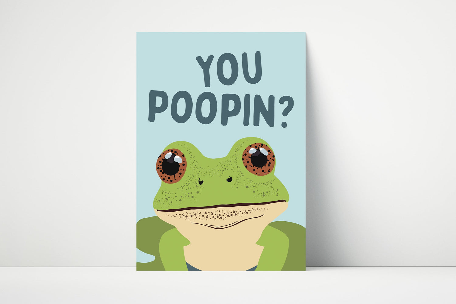 Funny bathroom wall art with a cartoon frog and the text “You Poopin’?”, perfect for quirky and humorous toilet décor.
